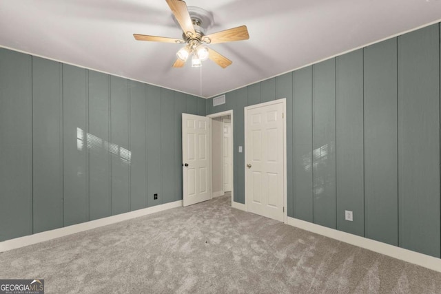 unfurnished bedroom with ceiling fan and carpet flooring