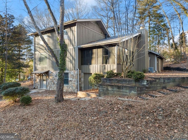 view of property exterior with a sunroom