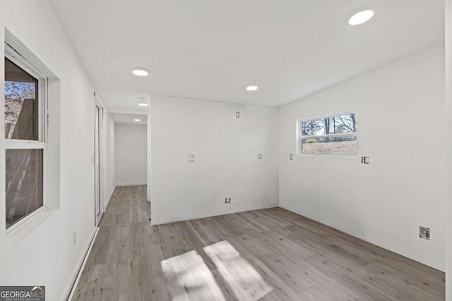 empty room with light hardwood / wood-style flooring