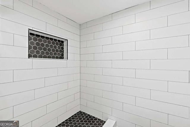 bathroom with tiled shower