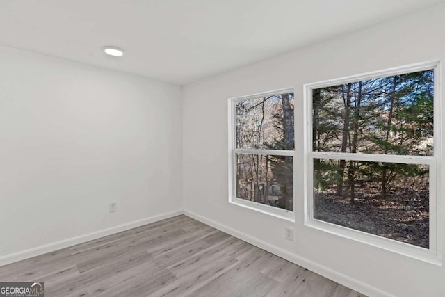 spare room featuring light hardwood / wood-style flooring