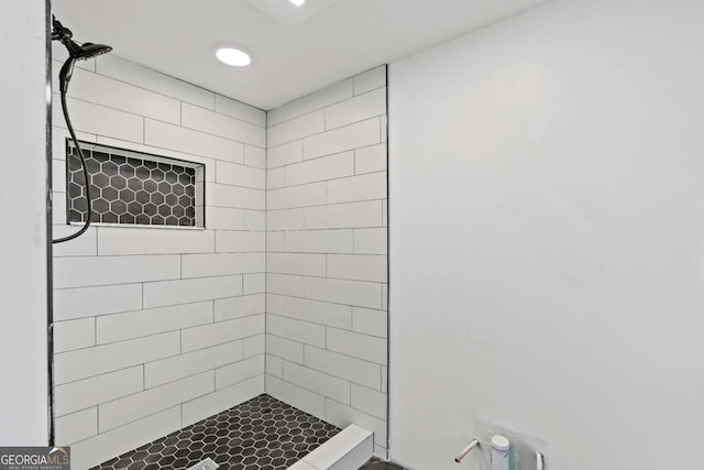 bathroom with tiled shower