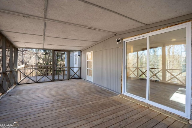 unfurnished sunroom with lofted ceiling