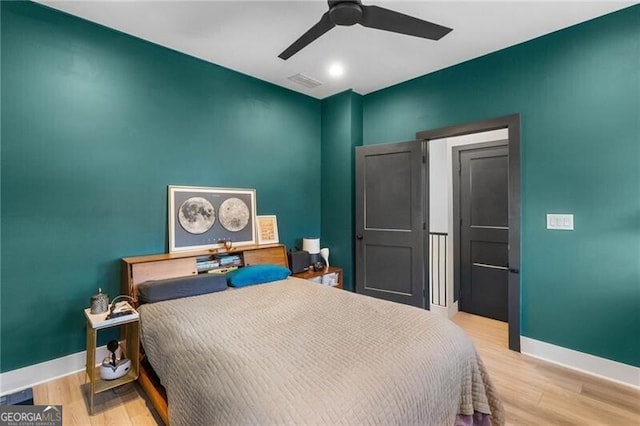 bedroom featuring ceiling fan and light hardwood / wood-style flooring