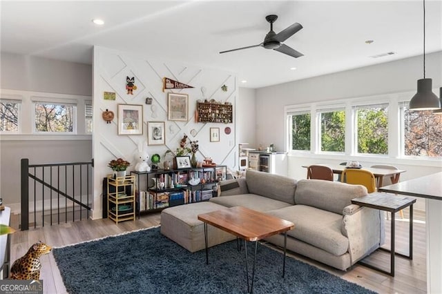 living room with wood-type flooring and ceiling fan