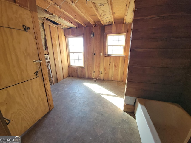 unfurnished room with wooden walls