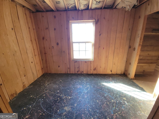 empty room featuring wooden walls