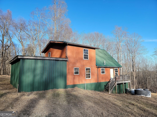 view of property exterior with a deck