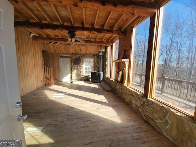 interior space with ceiling fan and beam ceiling