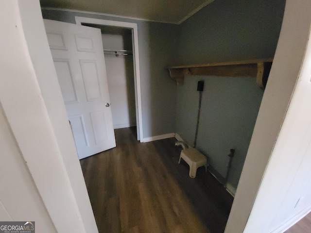 clothes washing area with dark wood-type flooring