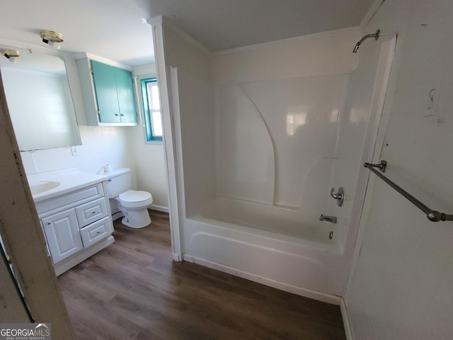 full bathroom featuring washtub / shower combination, vanity, toilet, hardwood / wood-style flooring, and crown molding