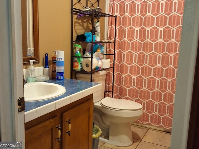 bathroom featuring tile patterned flooring, vanity, and toilet