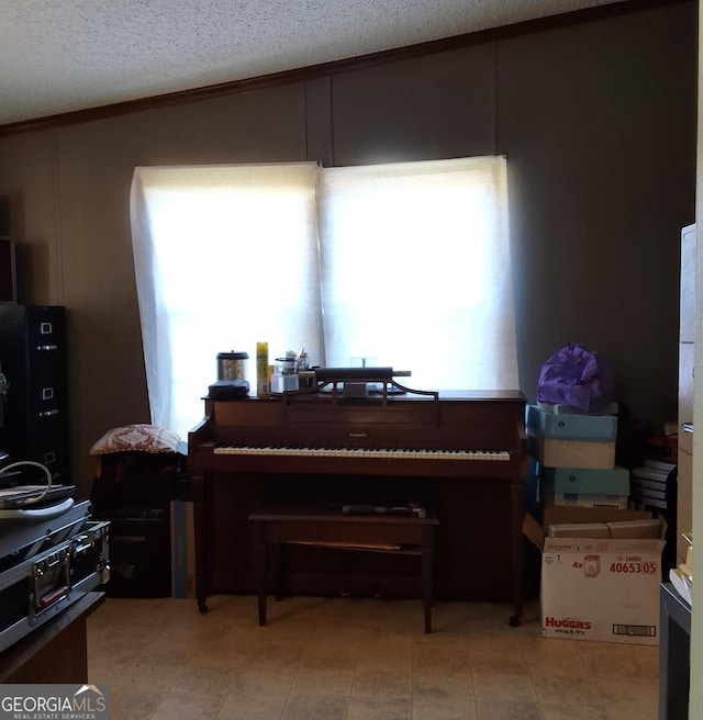 miscellaneous room with a textured ceiling