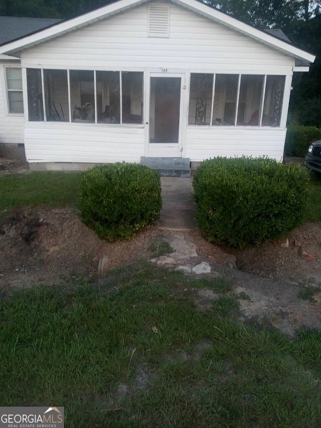 view of front facade featuring a sunroom