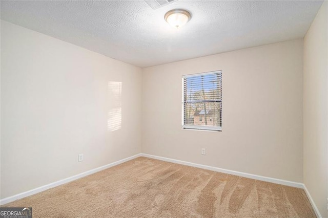 unfurnished room featuring carpet floors and a textured ceiling