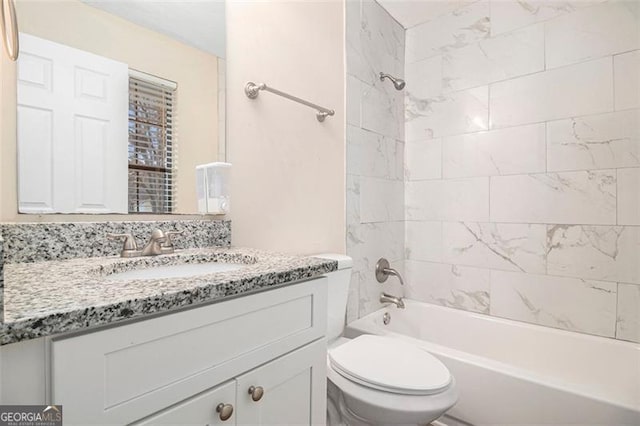 full bathroom featuring vanity, toilet, and tiled shower / bath