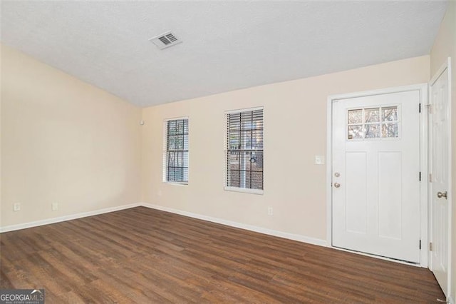 entrance foyer with dark hardwood / wood-style floors