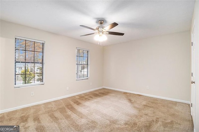 carpeted empty room featuring ceiling fan