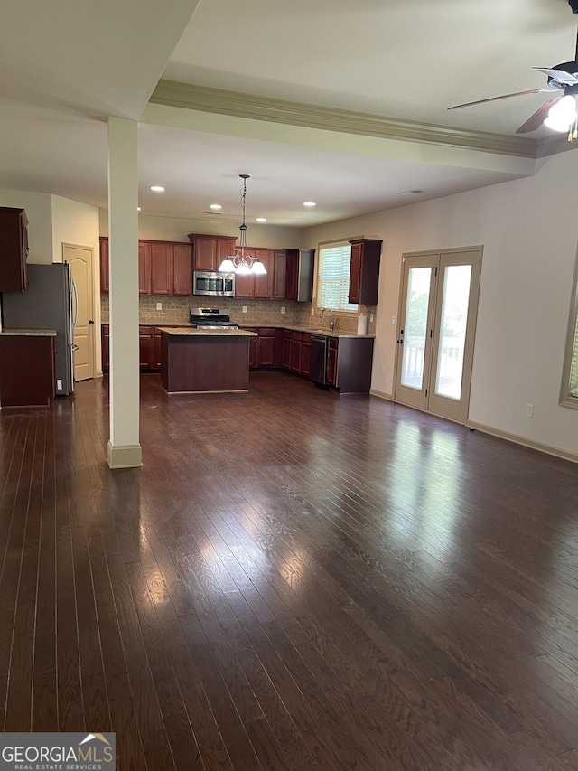 interior space with dark hardwood / wood-style floors, ceiling fan, ornamental molding, and sink