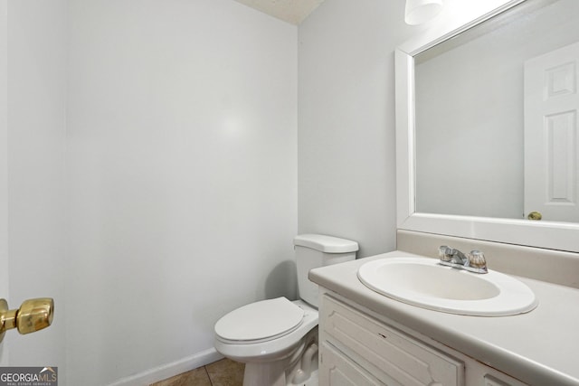 bathroom with tile patterned floors, vanity, and toilet