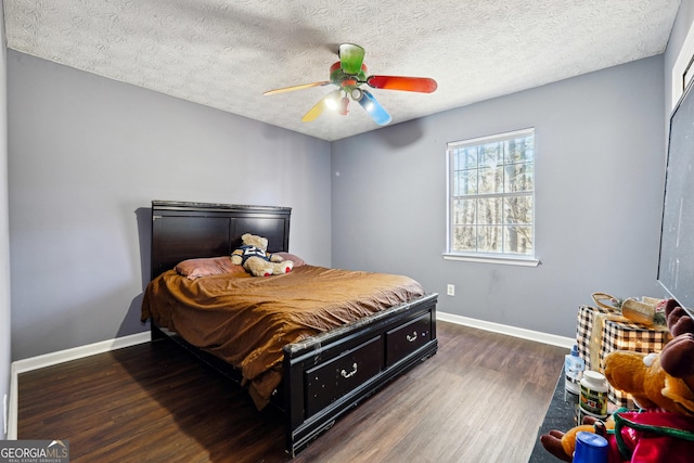 bedroom with dark hardwood / wood-style flooring, a textured ceiling, and ceiling fan