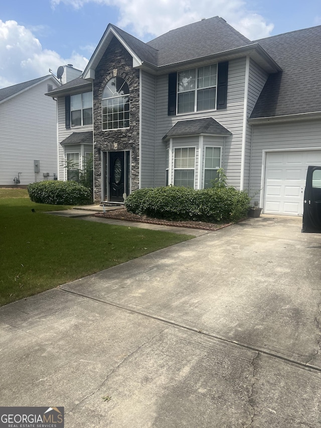 view of front property with a garage and a front lawn