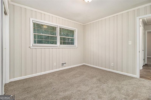 unfurnished room with carpet flooring and crown molding