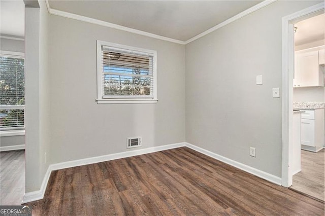 spare room with hardwood / wood-style flooring and ornamental molding