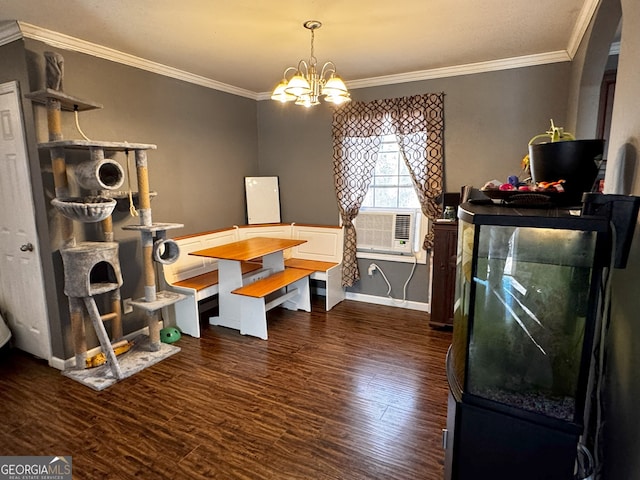 dining room featuring dark hardwood / wood-style floors, cooling unit, ornamental molding, and a chandelier