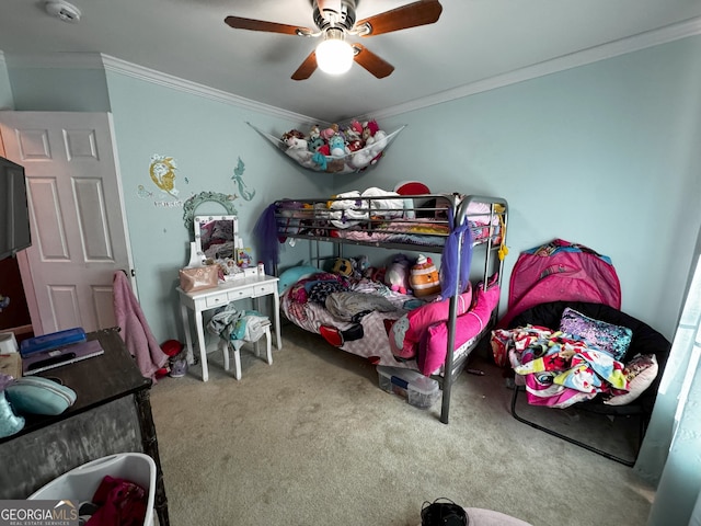 carpeted bedroom with ceiling fan and crown molding