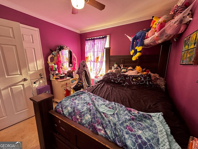 carpeted bedroom featuring ceiling fan and ornamental molding