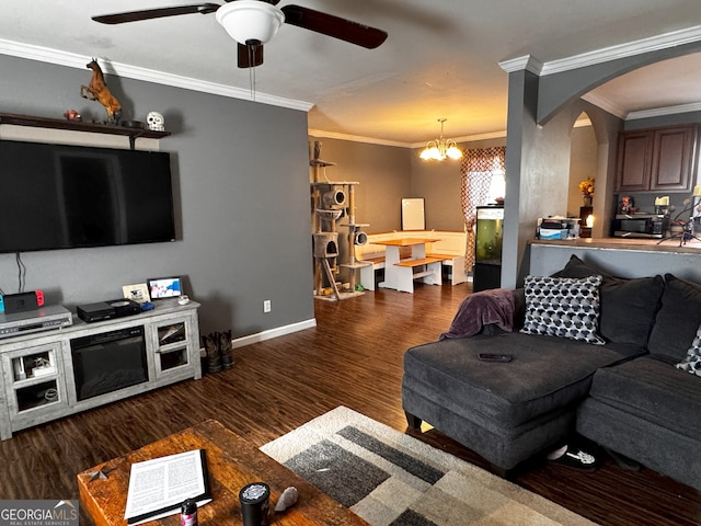 living room featuring ceiling fan with notable chandelier, dark hardwood / wood-style floors, and ornamental molding