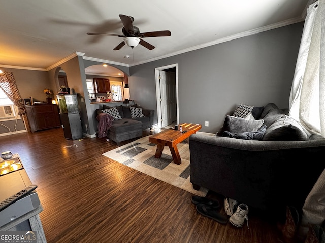 living room featuring ceiling fan, a healthy amount of sunlight, dark hardwood / wood-style floors, and ornamental molding