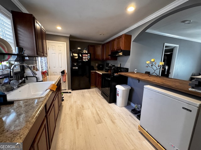 kitchen featuring ornamental molding, sink, black appliances, and light hardwood / wood-style flooring