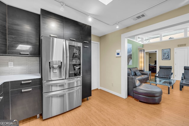 kitchen with stainless steel fridge with ice dispenser, light wood-type flooring, and track lighting