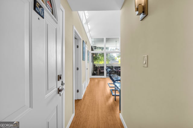 hallway featuring light hardwood / wood-style floors and floor to ceiling windows