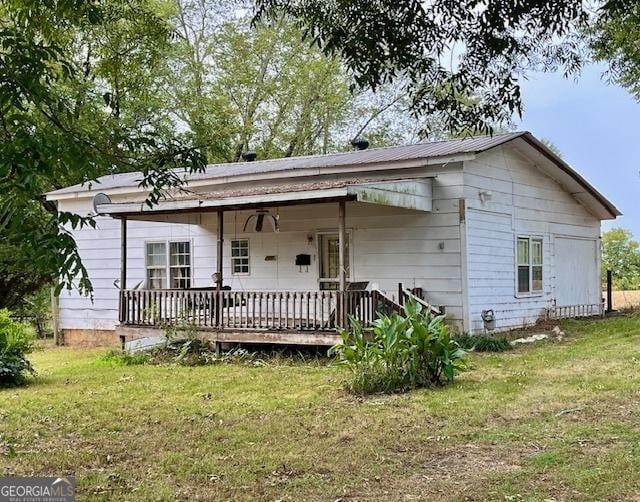 back of property featuring a lawn