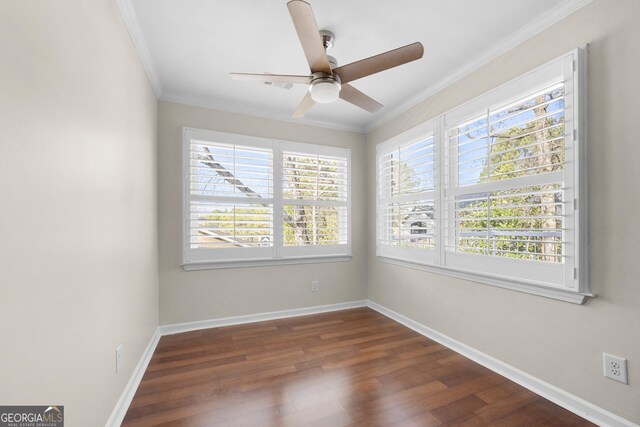 spare room featuring crown molding, dark hardwood / wood-style flooring, and ceiling fan