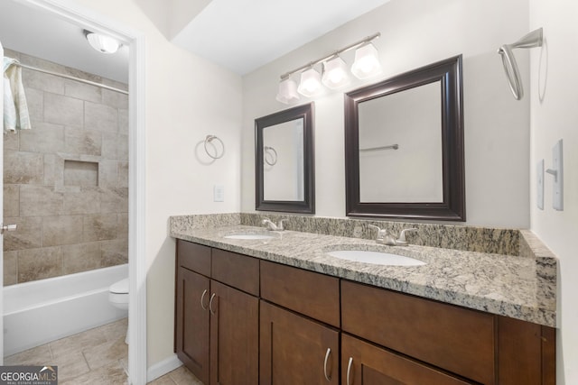 full bathroom featuring vanity, toilet, and tiled shower / bath combo