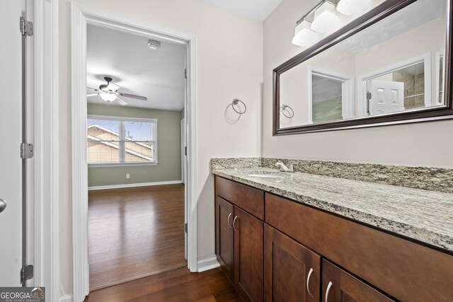 bathroom featuring vanity, hardwood / wood-style flooring, and ceiling fan