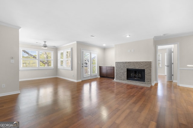 unfurnished living room with ceiling fan, dark wood-type flooring, and ornamental molding