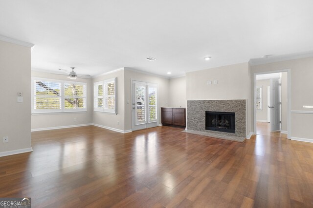 unfurnished living room with crown molding and dark hardwood / wood-style flooring