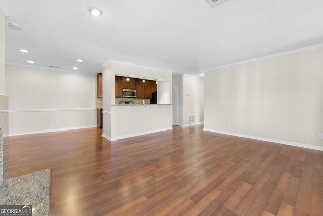 unfurnished living room with dark wood-type flooring and crown molding