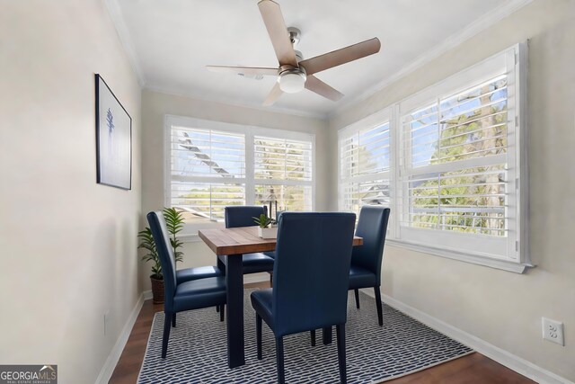 dining area featuring dark hardwood / wood-style floors, ceiling fan, and ornamental molding