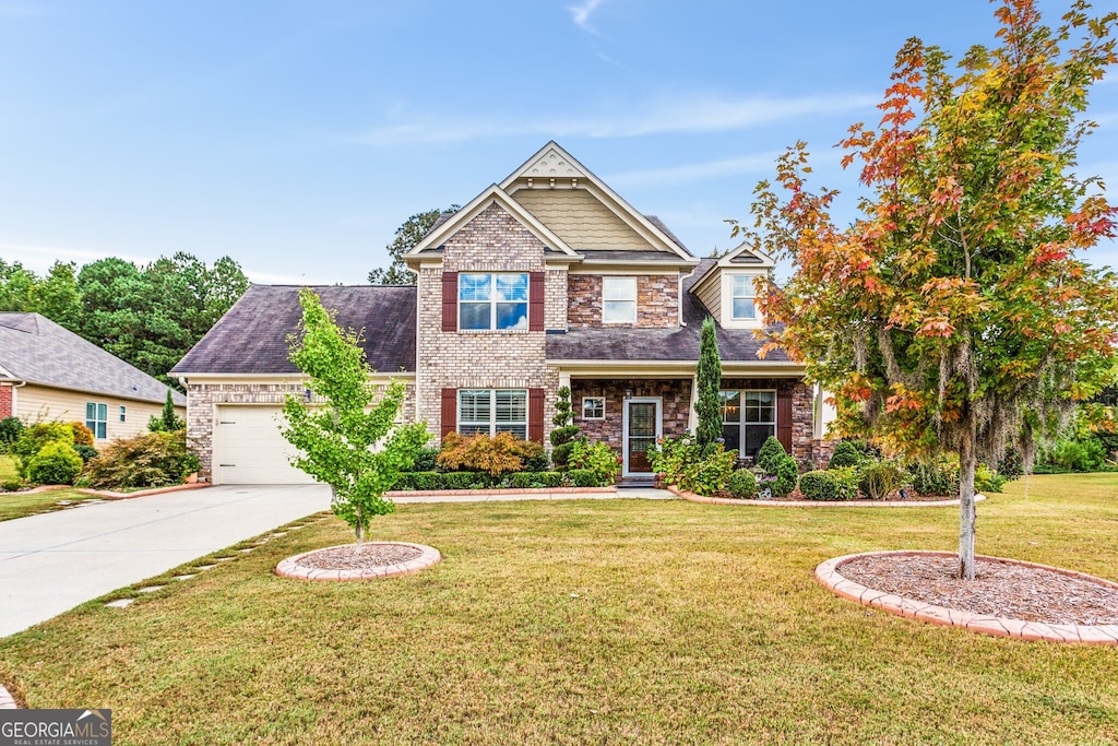 craftsman house featuring a front yard and a garage