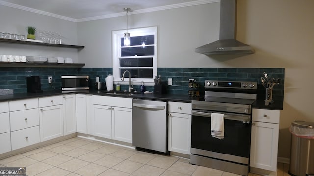 kitchen featuring backsplash, stainless steel appliances, sink, wall chimney range hood, and white cabinets