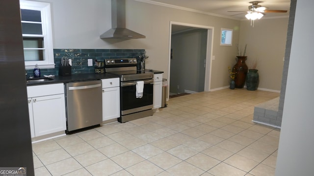 kitchen with white cabinetry, stainless steel appliances, wall chimney range hood, decorative backsplash, and ornamental molding