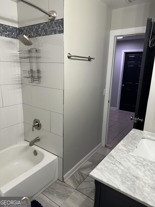 bathroom featuring vanity and tiled shower / bath combo