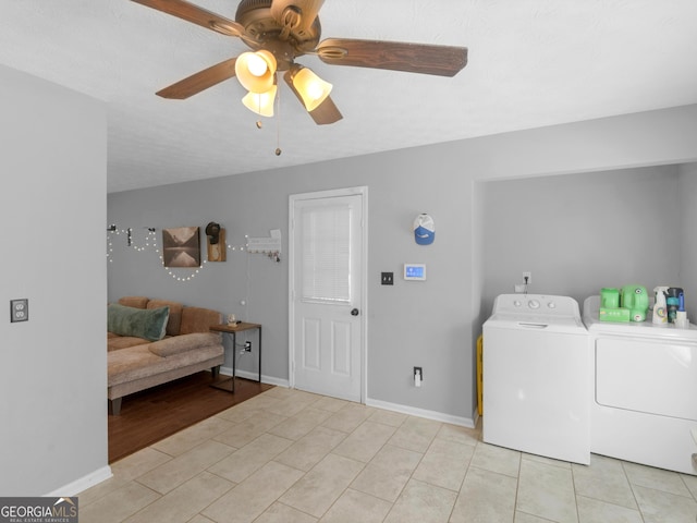 laundry area with independent washer and dryer, ceiling fan, and light tile patterned flooring