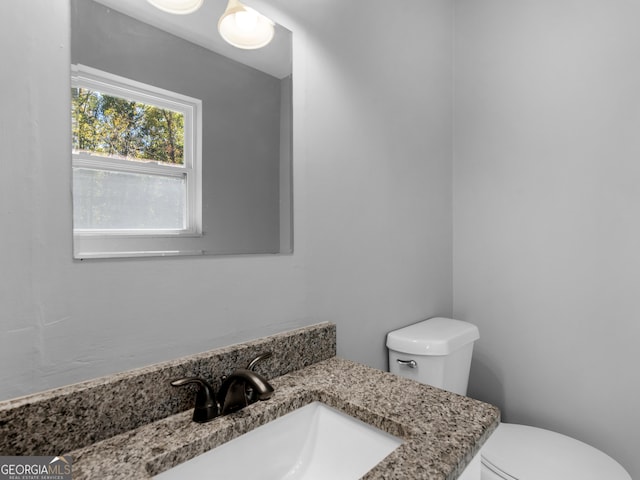 bathroom featuring vanity and toilet